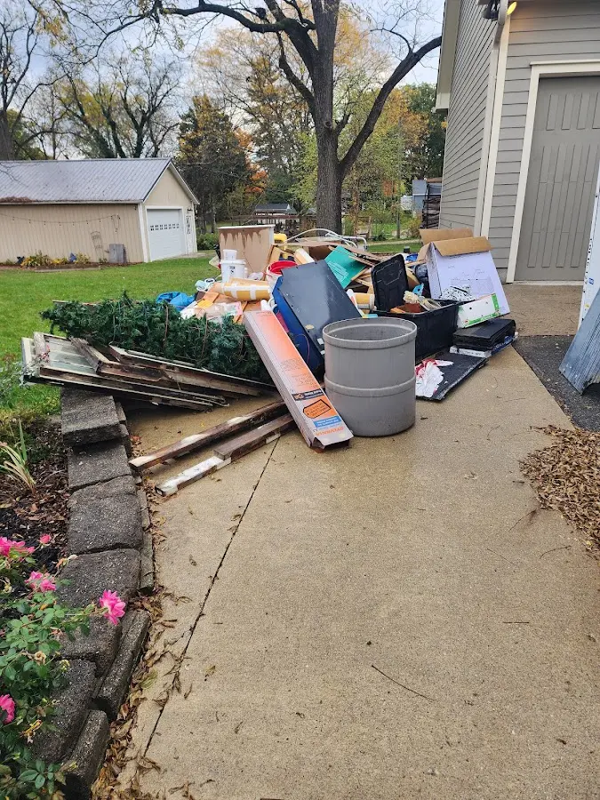 Dumpster being loaded with debris for Estate Cleanout Dumpster Rental in Old Tappan